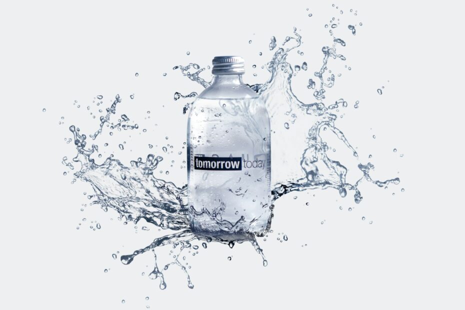 a bottle of water with water splashing around it